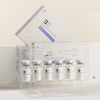 Set of medical vials with a clear plastic holder on a light background