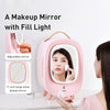 Pink makeup mirror with fill light and adjustable features, used by a person applying makeup.