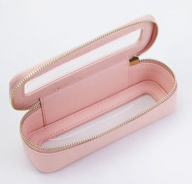 Pink jewelry case with gold zipper on a white background