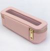 Pink pencil case with a gold zipper on a light gray background