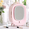 Pink vanity mirror with floral decorations on a white surface