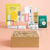 Collection of skincare products and a box on a peach background